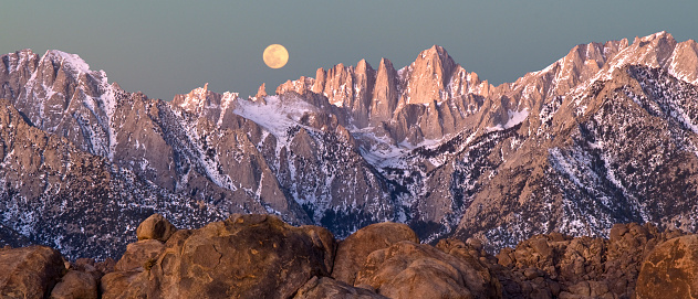 Full moon setting over the Sierra Nevada Crest, California.