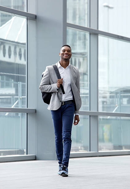 Handsome young man walking at station with bag Full length portrait of a handsome young man walking at station with bag standing on subway platform stock pictures, royalty-free photos & images