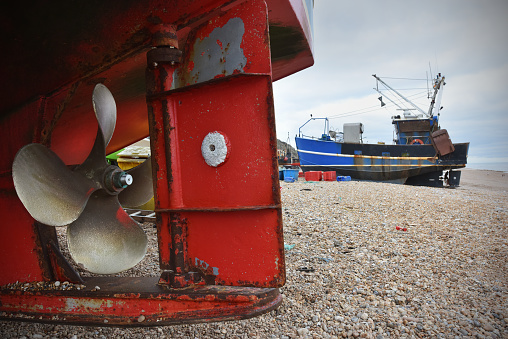 The rudder and propeller of a fishing boat at Hastings beach
