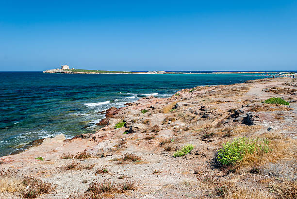 The coastline near Portopalo (Sicily) The coastline near Portopalo (Sicily), and the island of Capo Passero in the background portopalo stock pictures, royalty-free photos & images