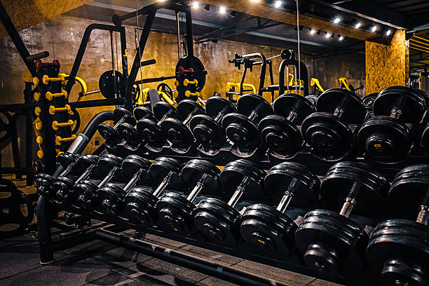 Rows of black dumbbells in gym center