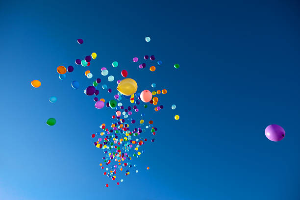 istock Colorful Balloons flying in the sky party 516417028