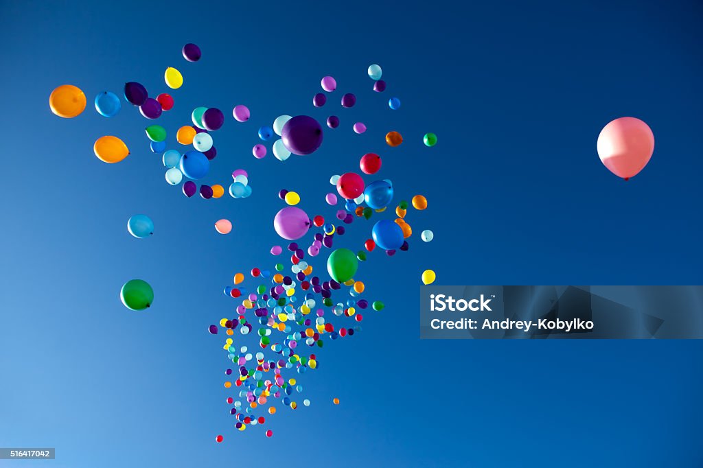 Colorful Balloons flying in the sky party colorful balloons on a blue sky background Levitation Stock Photo