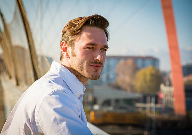 istock Handsome young man outside wearing white shirt 516417746