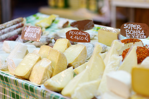 Large selection of cheeses on typical italian farmer market