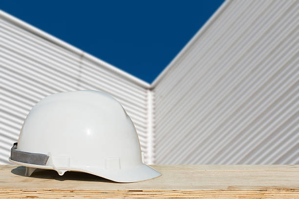 istock Safety helmet with over Construction site background. 516418738