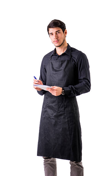 istock Young chef or waiter wearing black apron isolated 516419324