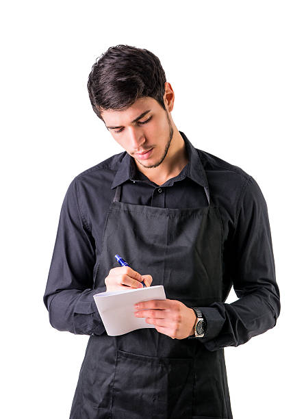 istock Young chef or waiter wearing black apron isolated 516419390