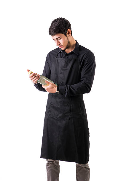 istock Young chef or waiter wearing black apron isolated 516419492