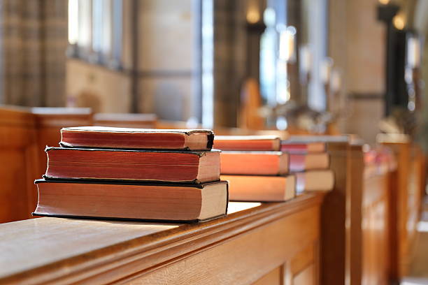 istock Bible book in the sunny church 516420238