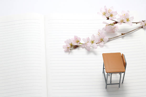 Study desk and cherry blossoms. Study desk and cherry blossoms on the notebook. high school enrollment stock pictures, royalty-free photos & images