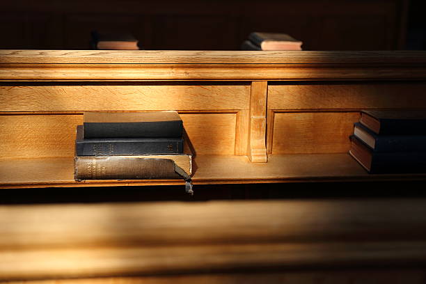 istock Bible book in the sunny church 516420422