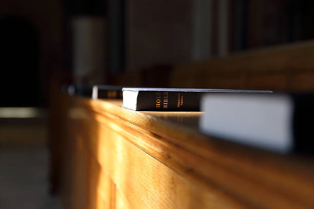 istock Bible book in the sunny church 516420478