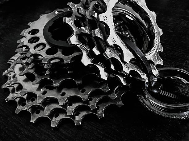 istock bicycle gear cogwheel and chain over wooden surface 516420788