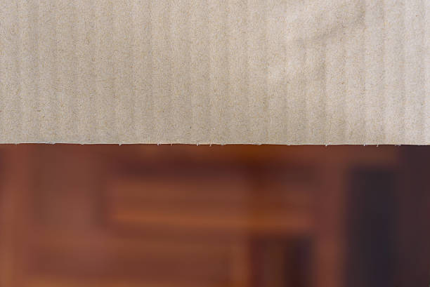 istock Cardboard paper with blur wooden background 516422282