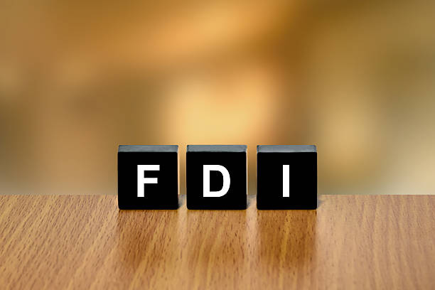 FDI or Foreign direct investment on black block stock photo