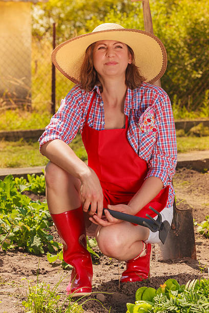 istock woman with gardening tool working in garden 516422510