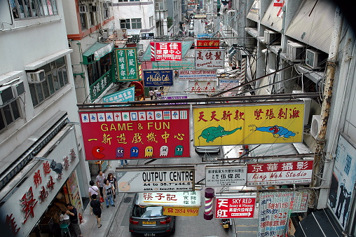 Hong Kong, China - June 5th 2011 A street in Hong Kong with business signs in both English and Cantonese stretching down the street.