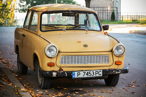 Ruse, Bulgaria - September 29, 2014: Old yellow Trabant 601s car stands parked on a street side