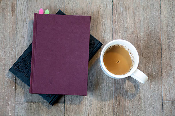 istock book and coffee cup on wooden floor 516424454