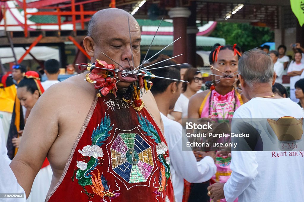 vegetarian festival 2014 in phuket, thailand Phuket Town, Thailand - October 01.2014: Entranced  Mah Song or Warrior with body piercing through the mouth and cheeks processing from Kathu Shrine to Phuket Town at the Vegetarian Festival on October 1st 2014 in Phuket, Thailand Annual Event Stock Photo