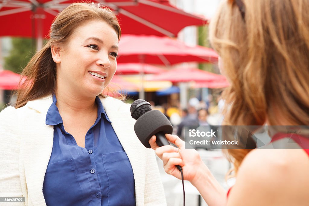 Outdoor Interview A woman being interviewed outdoors. Interview - Event Stock Photo