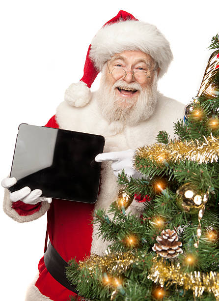 istock Real Santa Claus pointing to digital tablet 516425715