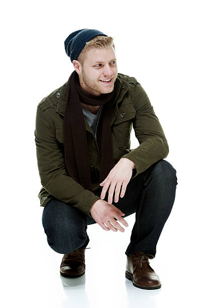 istock Cheerful man crouching and looking away 516426514