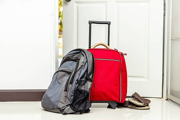istock red travel bag , backpack and shoes 516439147