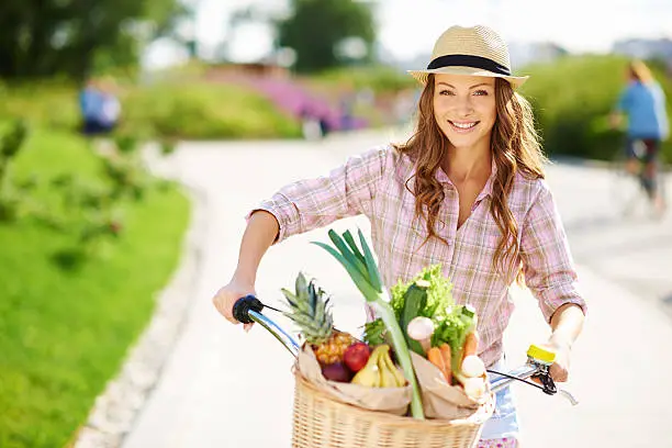 A portrait of a beautiful young woman carrying fresh fruit and vegetables home on her bicyclehttp://www.azarubaika.com/iStockphoto/2014_06_22_City_Bike.jpg