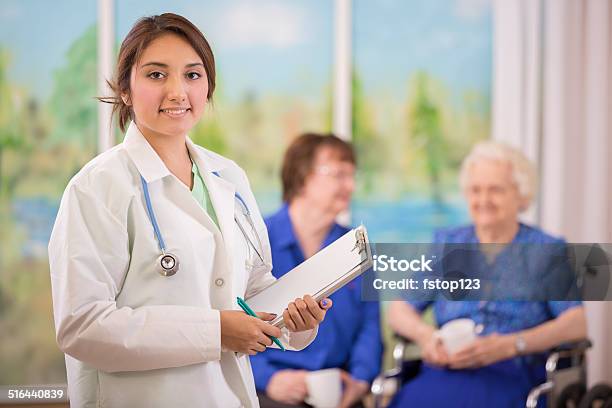 Latin Female Doctor Visits Elderly Woman Patient In Nursing Home Stock Photo - Download Image Now