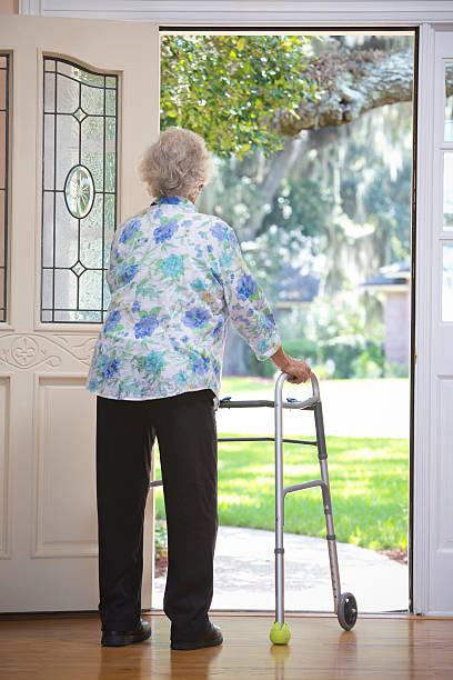 istock Elderly woman at door 516440959