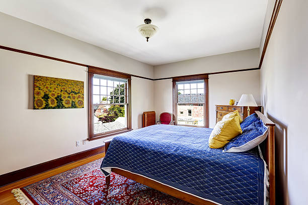 istock Bed with bright blue bedding and yellow pillows 516440991
