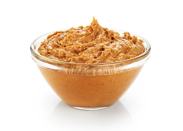 istock Bowl with peanut butter isolated on white background. 516443478