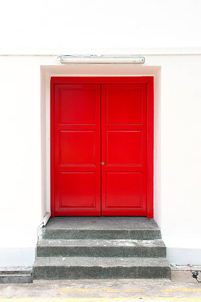 istock Red door on the white wall 516443719