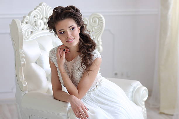 istock Young gorgeous bride is sitting in antique armchair 516443724
