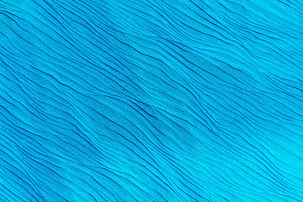 istock The Tighting bright blue silk fabric with waves 516444130