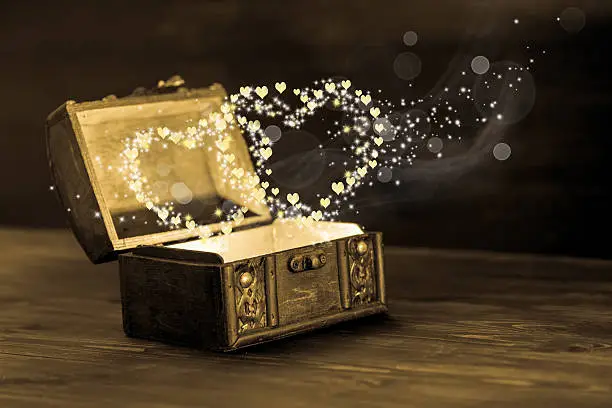 Photo of beautiful concept of vintage chest with light heart miracle