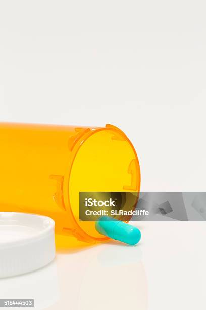 Aqua Colored Prescription Medicine Capsule And Bottle On White Background Stock Photo - Download Image Now