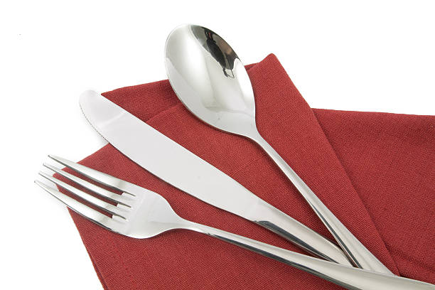 istock fork and knife on red napkin isolated 516445342