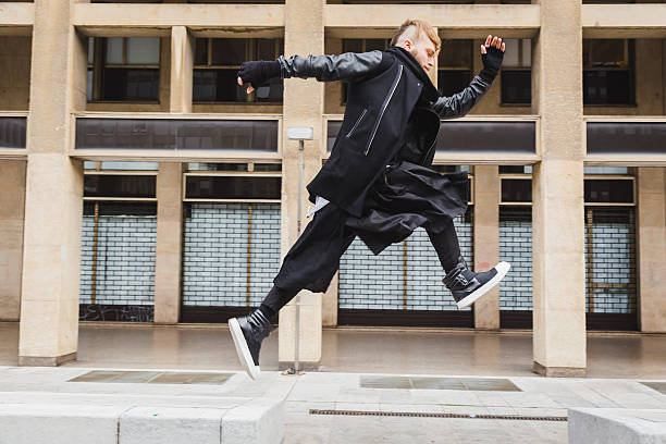 istock Stylish bearded man jumping in the street 516445484