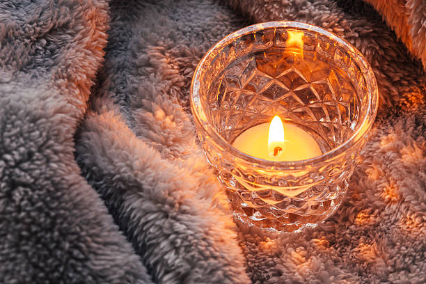 istock Cosy and soft winter background,candles on a blanket 516446196