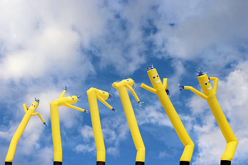 Row of dancing wind sock air puppets.