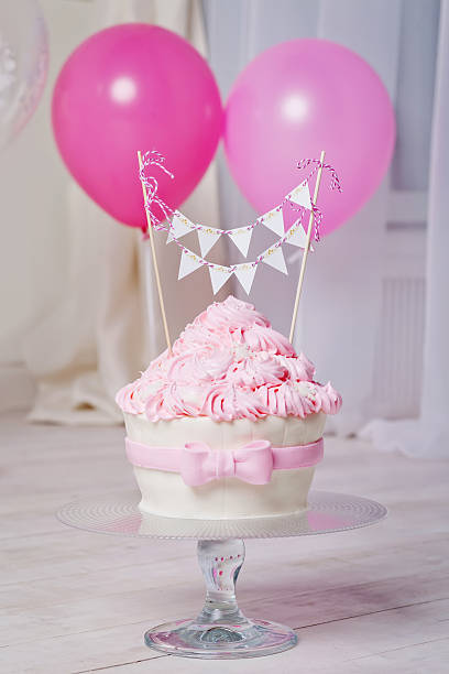 istock Festive cake and balloons. White and pink color 516446918