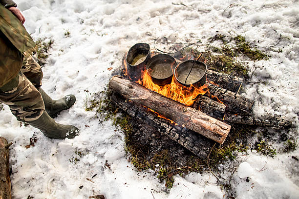 istock Cooking in winter hike in cauldron hanging over the fire 516447440