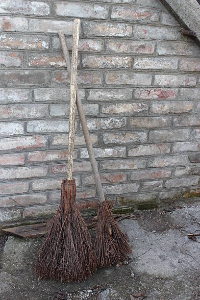 istock Brooms of branches on the brick wall background 516448962