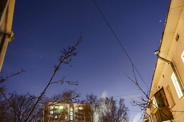 istock The starry sky and the moon over the buildings. 516449564