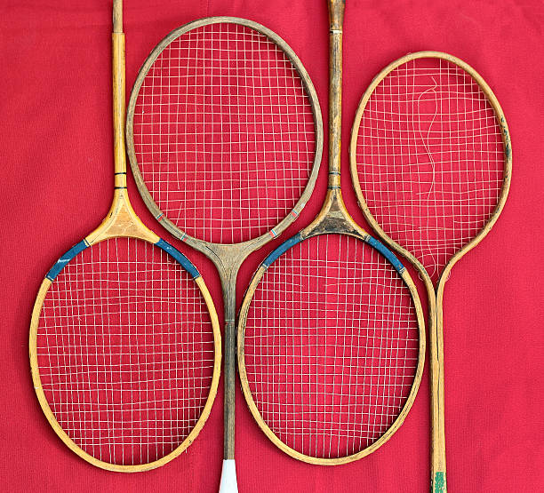 istock Old wooden badminton rackets on red background 516449828