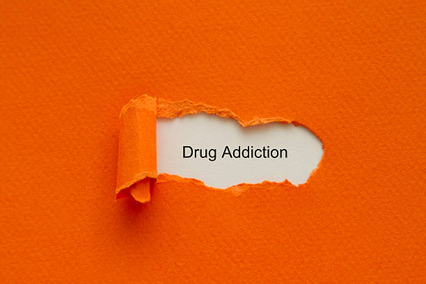 istock Drug Addiction written under torn paper. 516450830