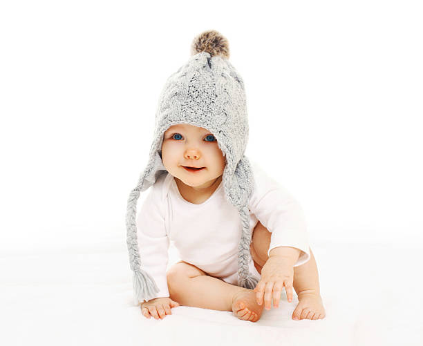 istock Portrait cute baby in grey knitted hat on white background 516452700